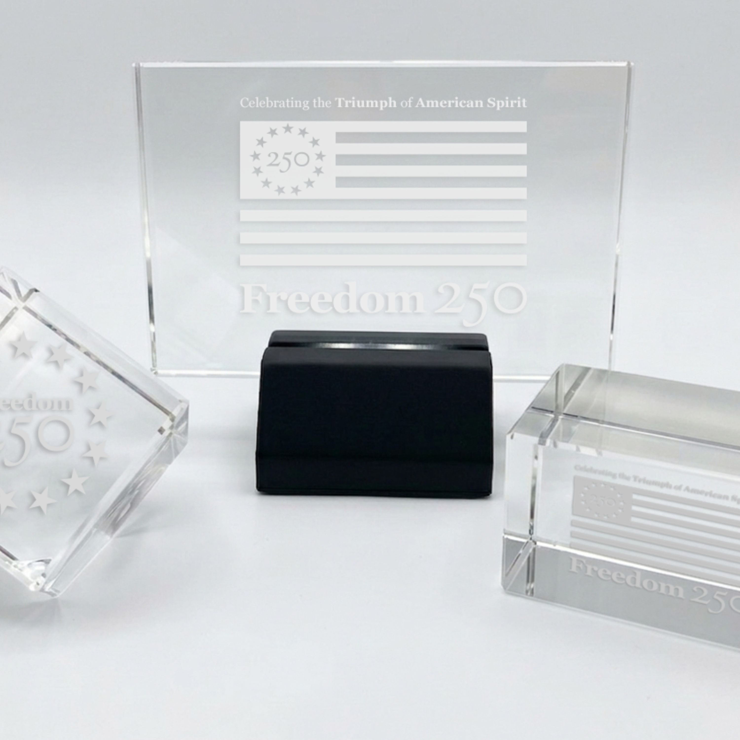 Clear glass items with 'Freedom 250' branding on a white background