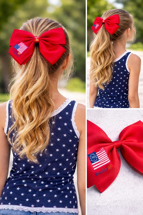 Girl with red hair bow featuring American flag design, wearing a blue star-patterned top.