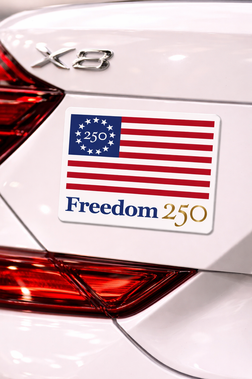 American flag sticker on a car with 'Freedom 250' text