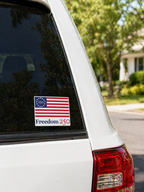 American flag sticker with 'Freedom 250' text on a car window