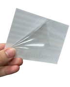 Hand holding a clear plastic sheet against a white background