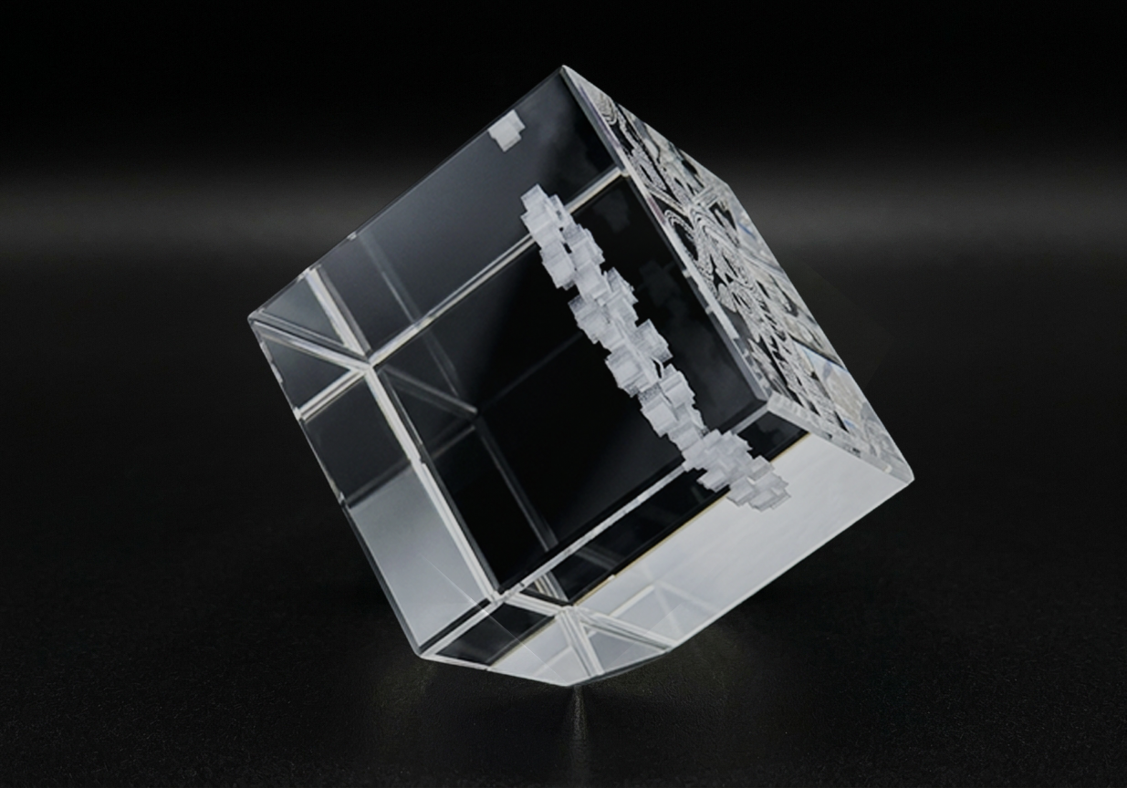 Crystal cube with intricate design on a black background