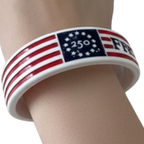 Wristband with American flag design and '250' and 'FREEDOM' text on a white background