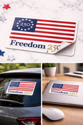 American flag sticker with 'Freedom 250' text on a car, laptop, and mouse.