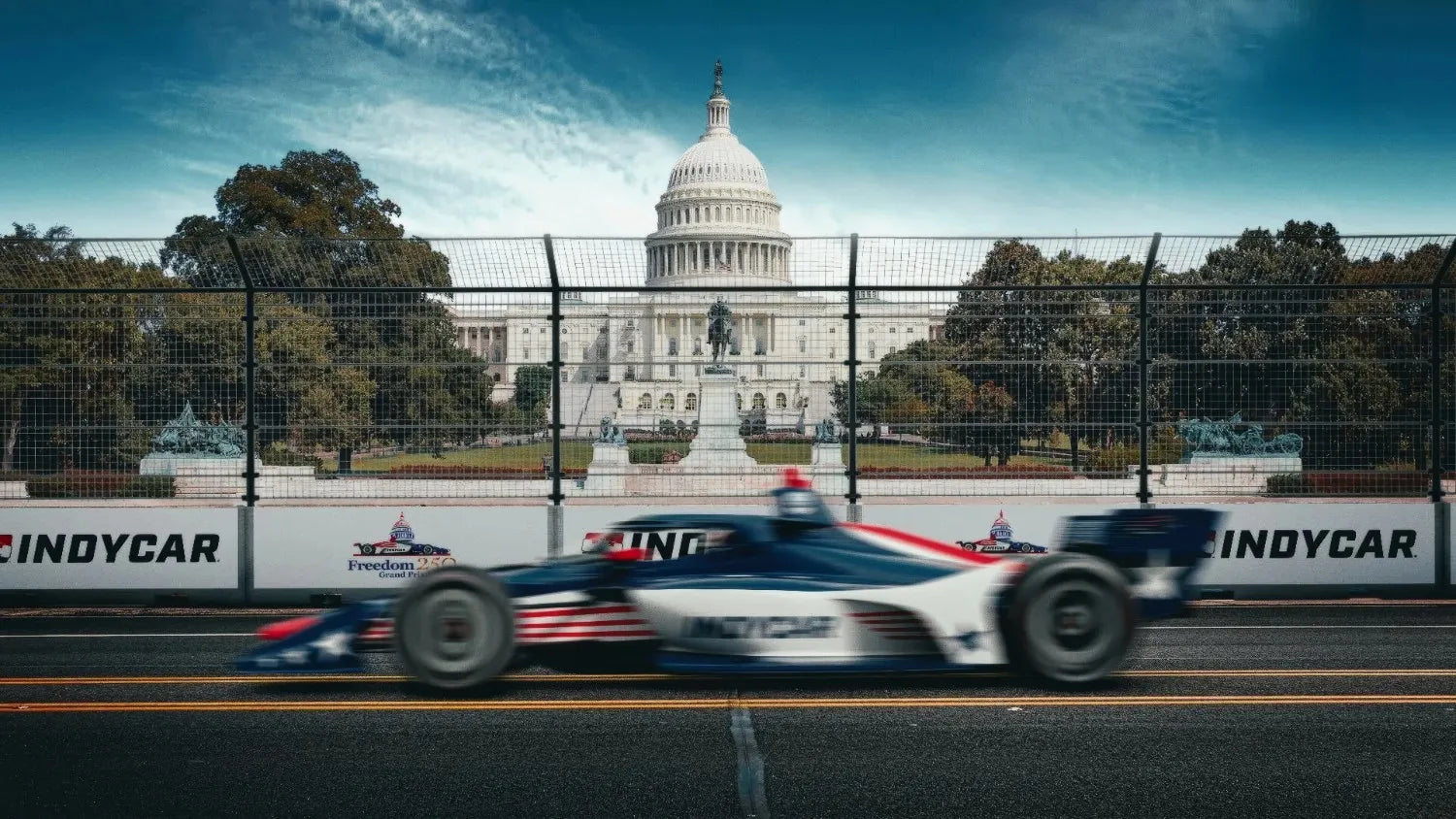 IndyCar racing on a track with the U.S. Capitol building in the background